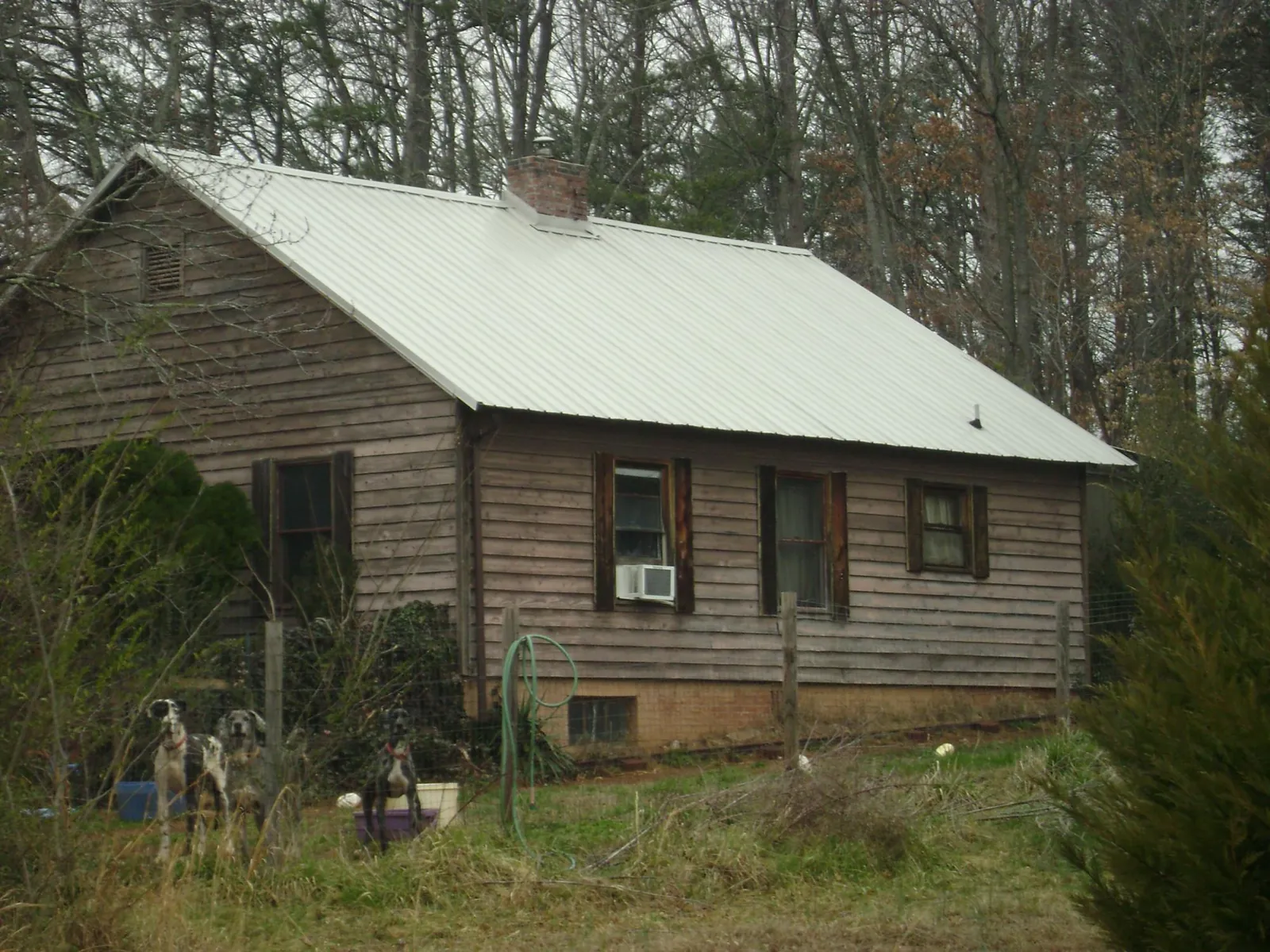 White metal roof on an old wood sided farmhouse, from a Metal Roof Installation job in Fresno
